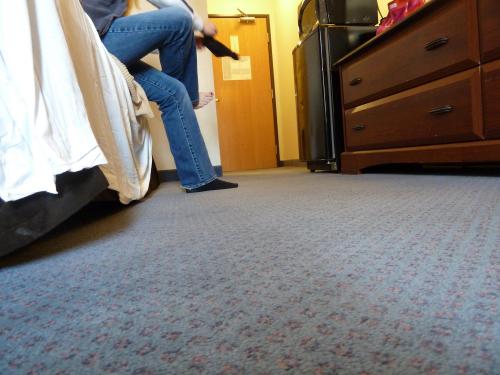 The wife (seen here putting on socks) could have watched the TV from where she sat!